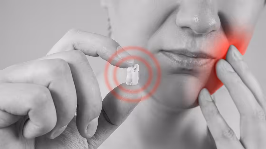 Dental extraction woman holds tooth