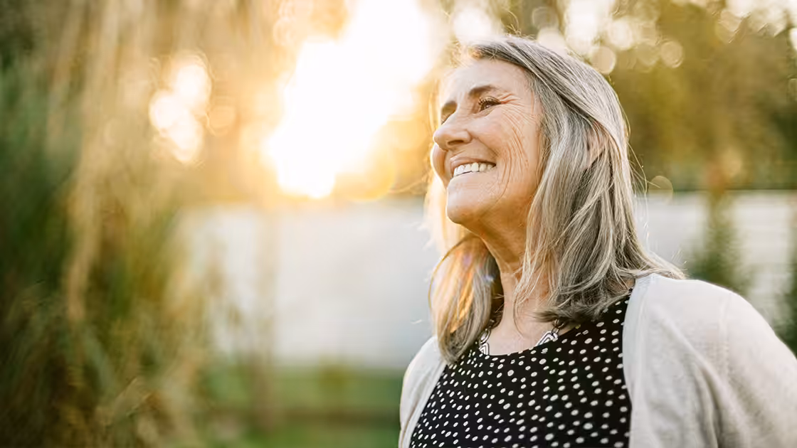 Denture patient smiles outdoors
